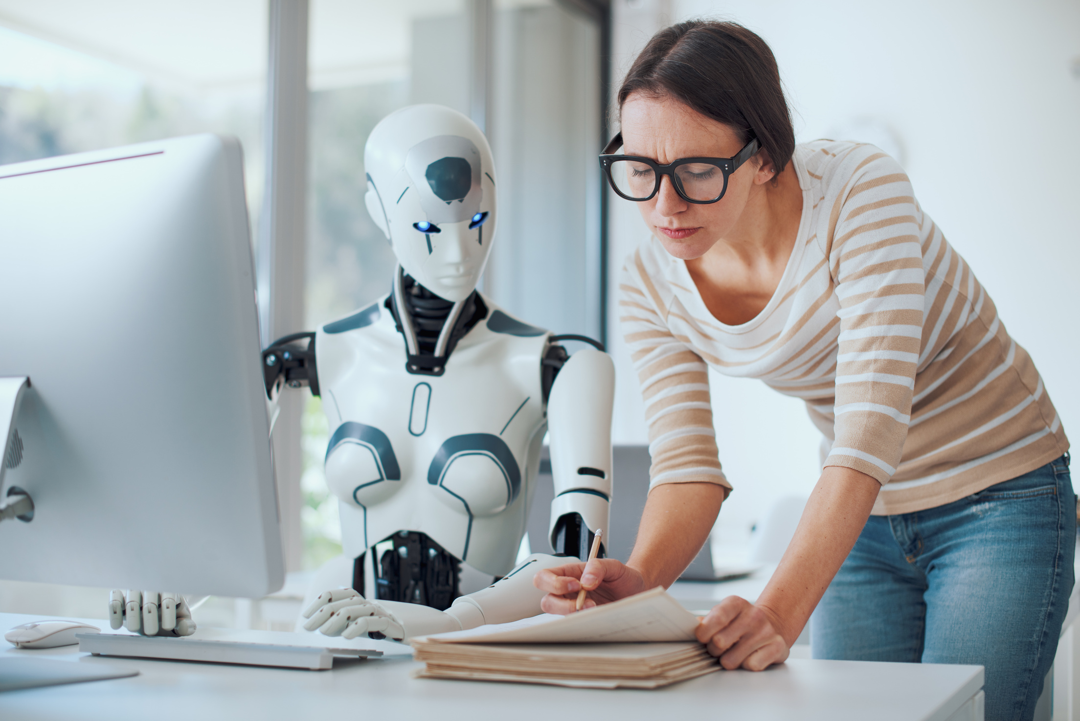 AI robotics assistant working alongside a person at a desk
